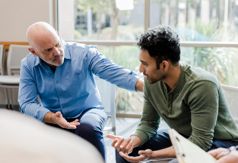 Two people trying to handling and resolve an aggressive verbal complaint in the public sector