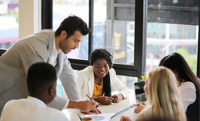 Group of employees talking to learning and development manager