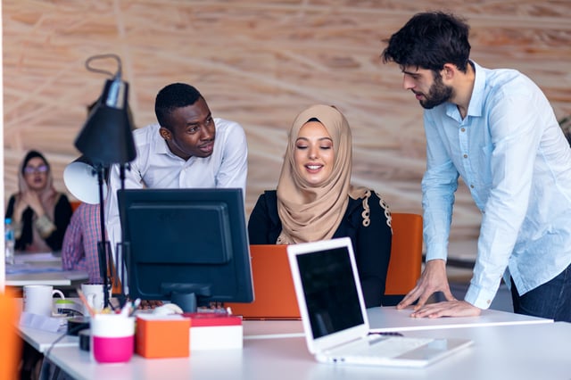 Three people discussing 4 ways to become more effectively assertive in the workplace