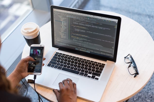 Person using a laptop to write a data protection impact assessment