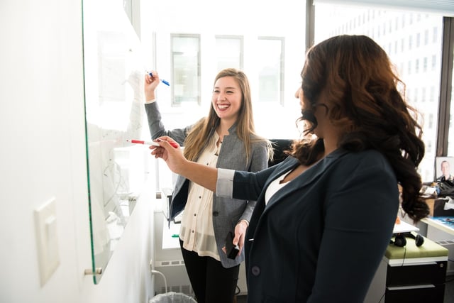 Two women learning how to support women in the workplace