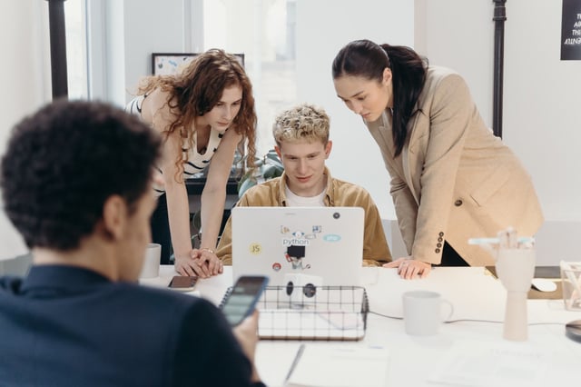 Group of employees learning how to make difficult decisions at work with example