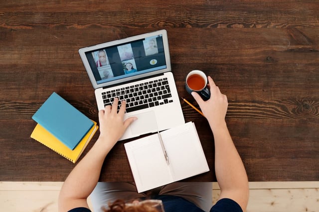 Person using their laptop to dial into a hybrid learning training course