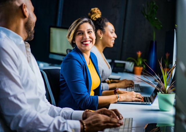 Three people talking about how to achieve female empowerment in the workplace