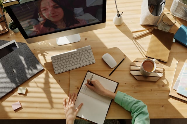 Person on a virtual call learning about the benefits of an online training course