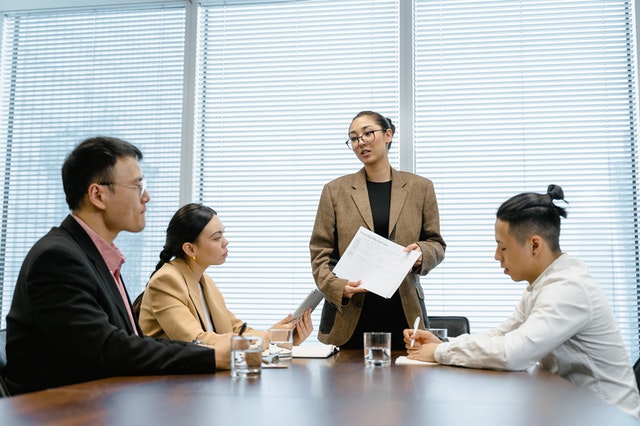 Four people having a difficult conversation at work