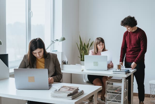 Three managers learning how effective their workplace wellness program is