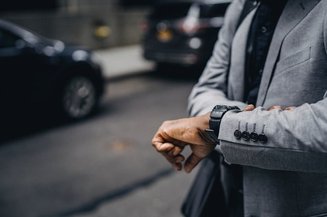 Person using their watch to improve from time management tips