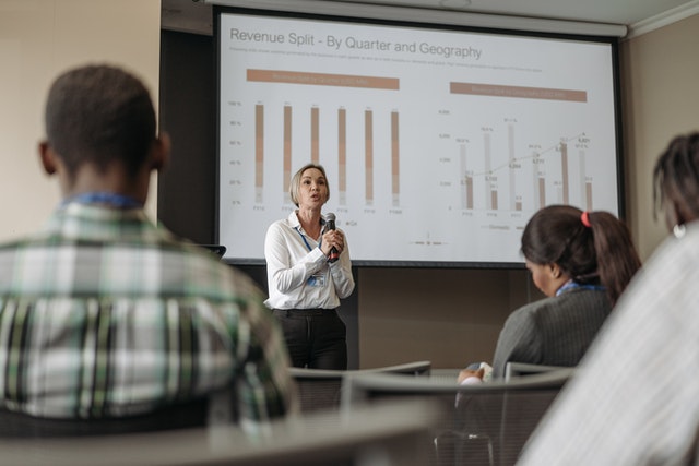 Person at the front using a powerful way to end a presentation