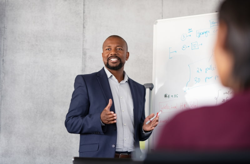 Person speaking in front of a crowd about how to create a employee training plan 