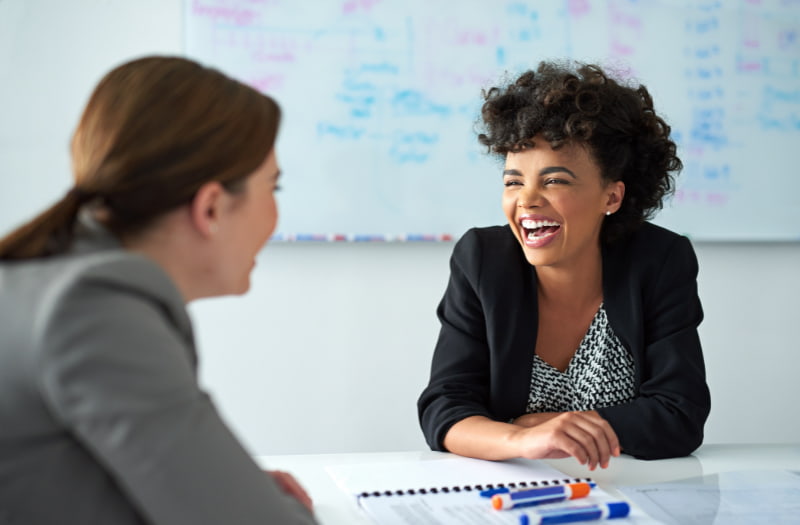 two people in the workplace talking and building rapport
