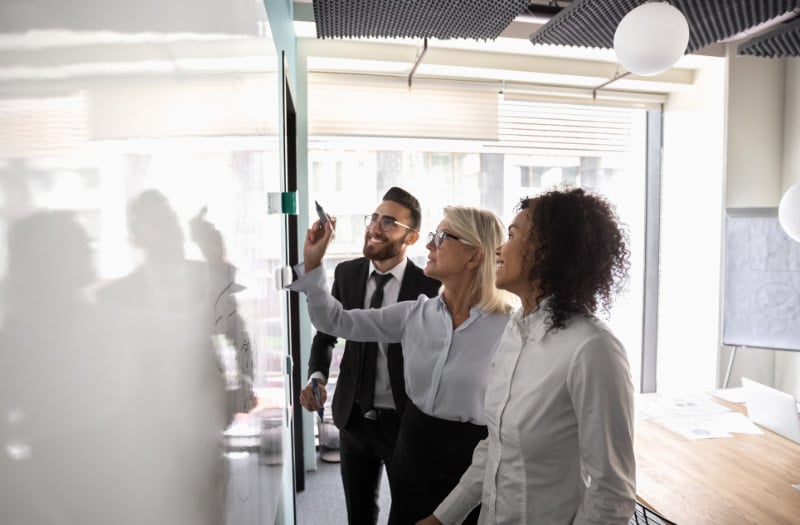 People using a whiteboard and learning how to support employee development