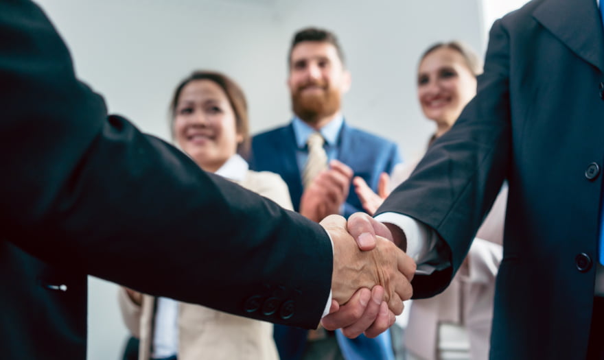 two people shaking hands on a stakeholder analysis