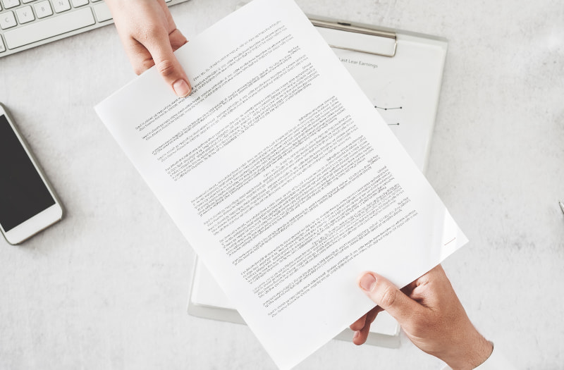Person handing over a contract to manage relationships within contract management