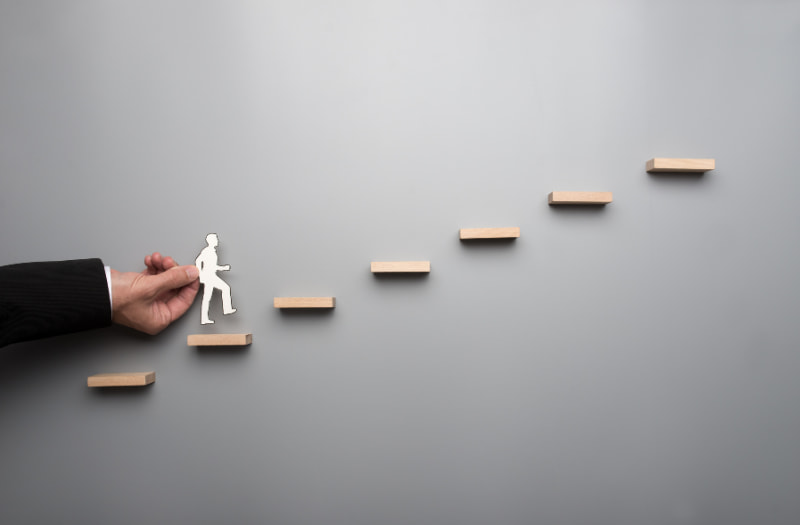 Person climbing a ladder to show managing up and why it's important