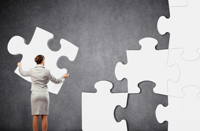Person using puzzle pieces to understand problem solving methods