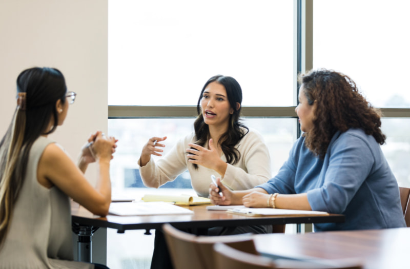 Group of employees talking about how to transition from employee to manager
