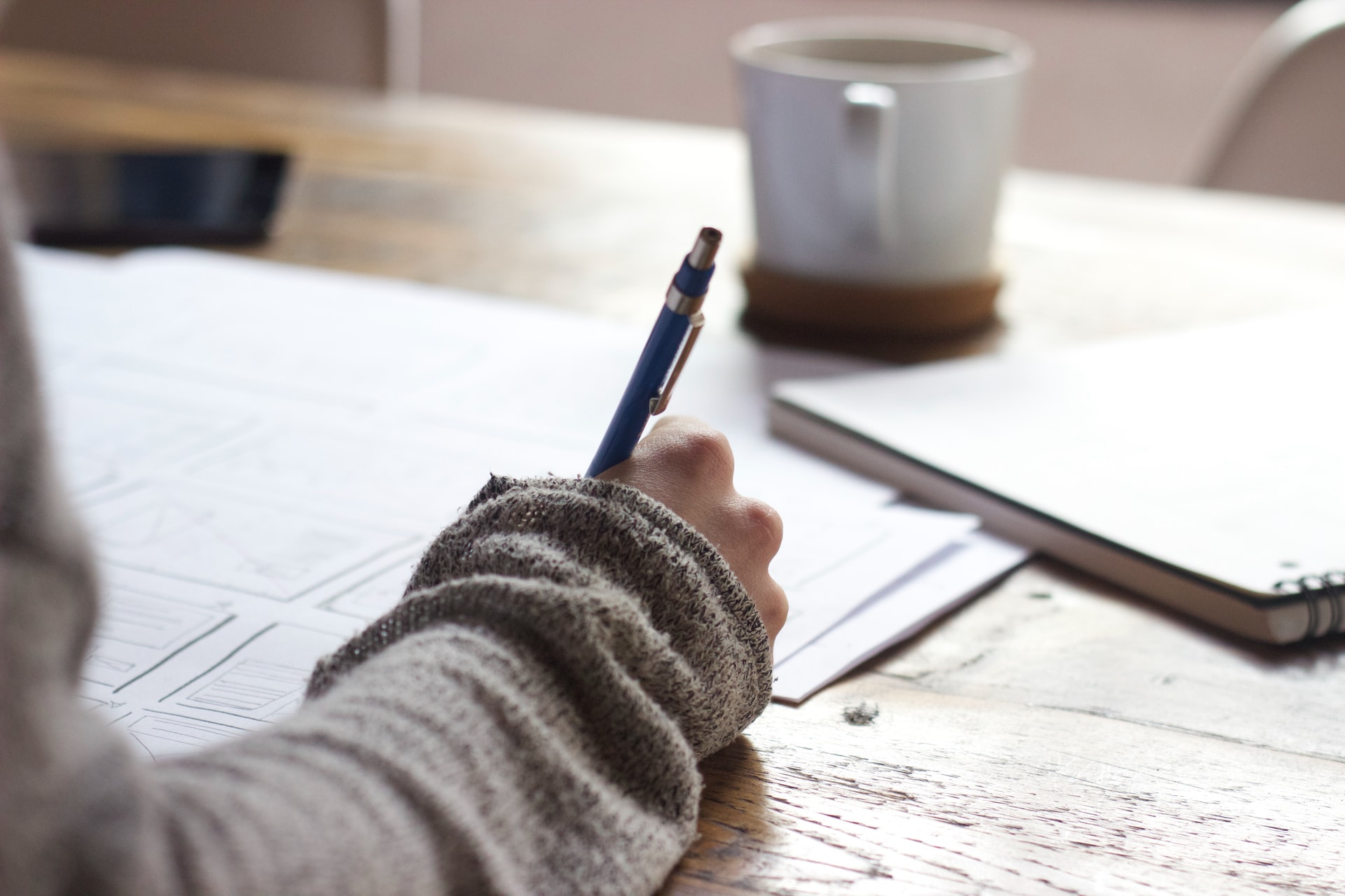 Person writing a report and gaining tips from expert Sue Calthorpe